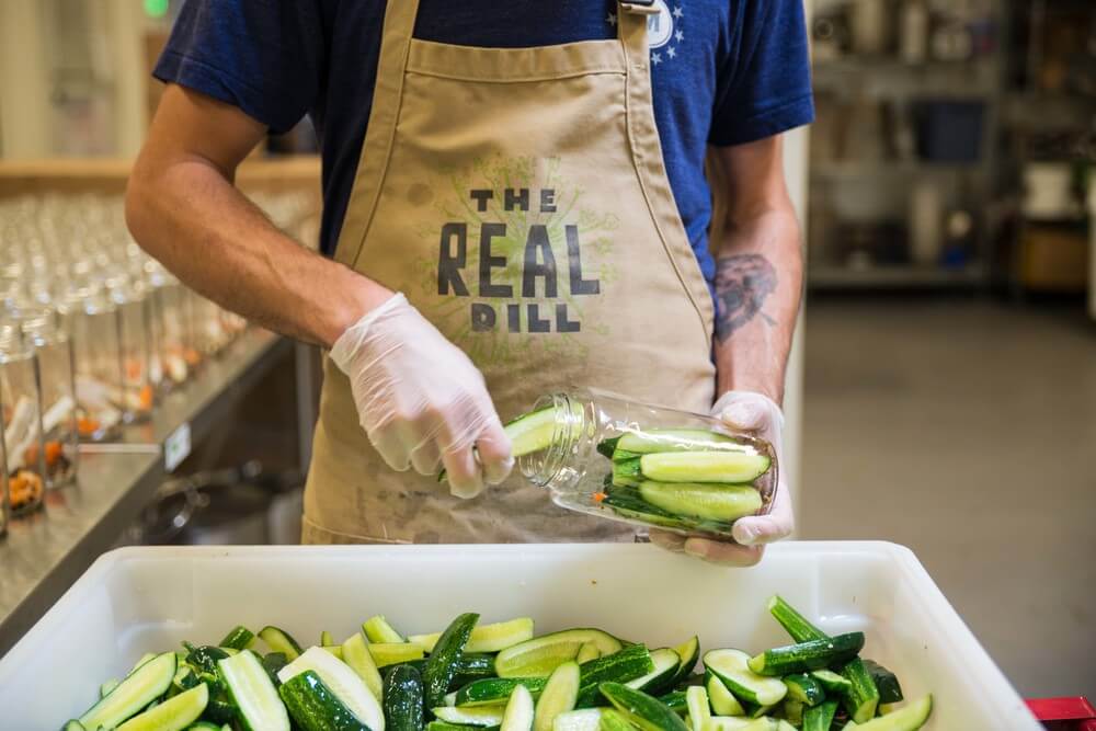 Pickels are bottled by a Real Dill employee in their kitchen