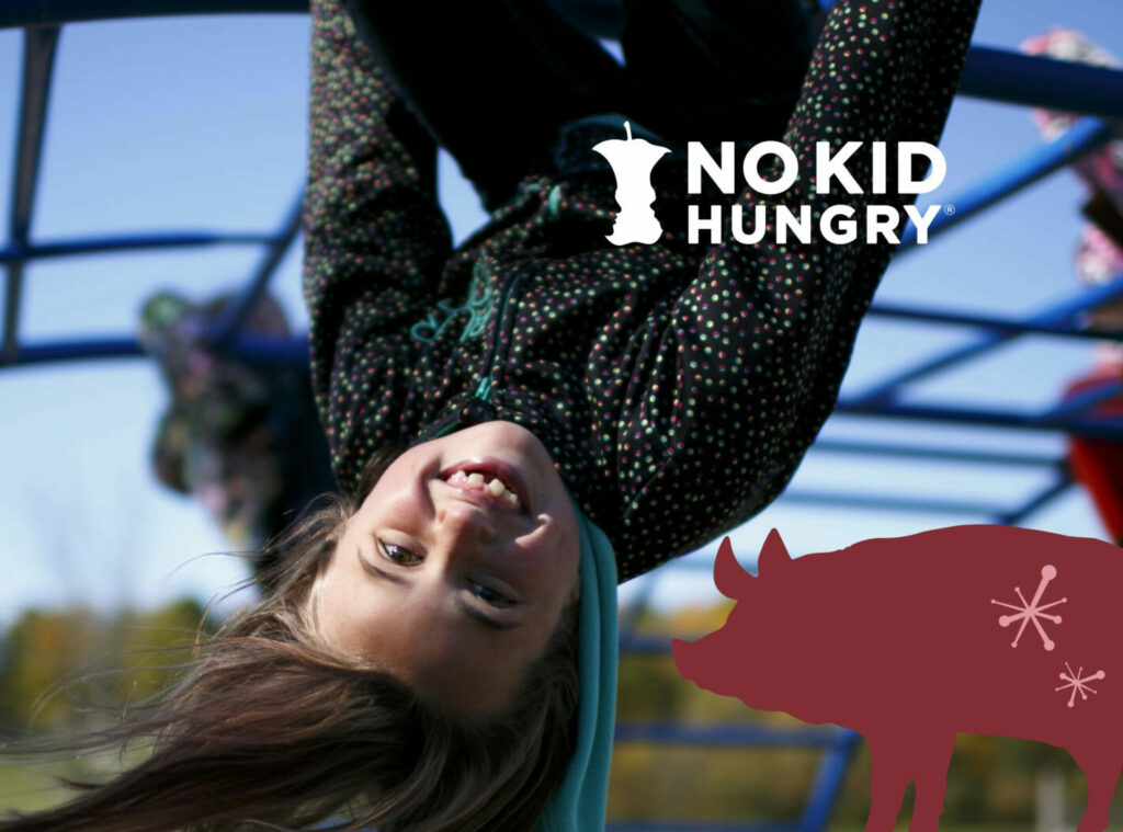 Child swinging on a playground with the No Kid Hungry Logo